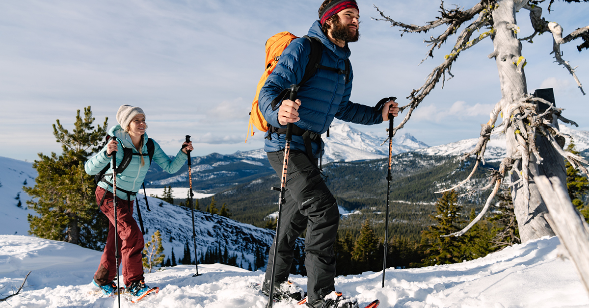 Man and woman snowshoeing during winter