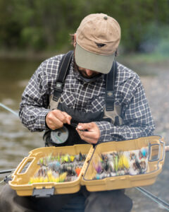 How is a fly tied to the line?