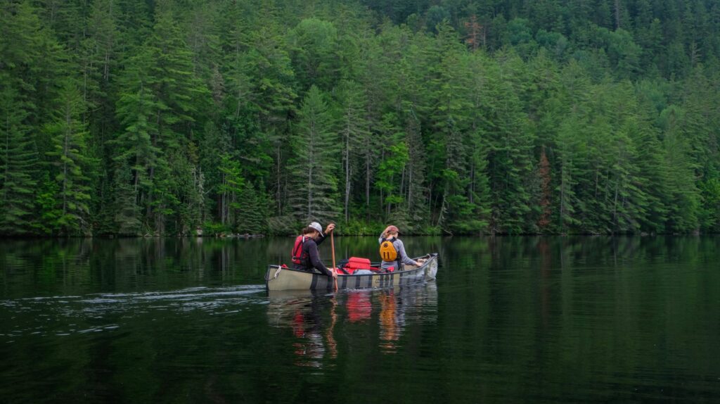 Canoeists lined up along the shore of the Dumoine River