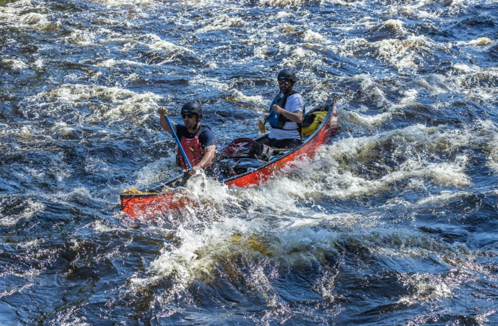 Experienced canoeists navigating a rapid on the Dumoine River in Quebec