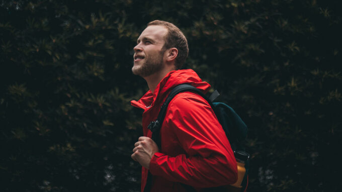 Man in the forest wearing a hard shell jacket