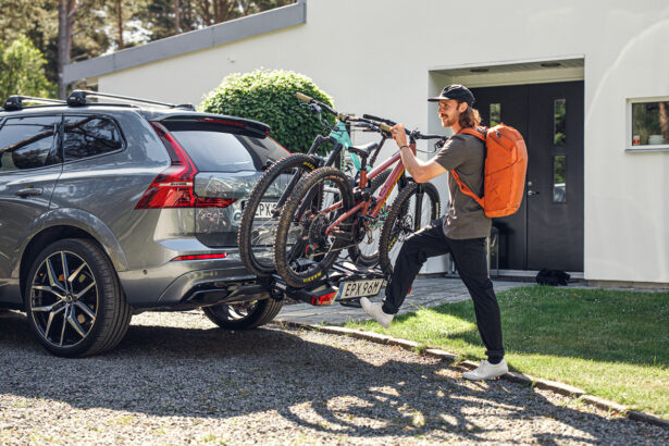 Man attaching his bikes to the car racks for bikes
