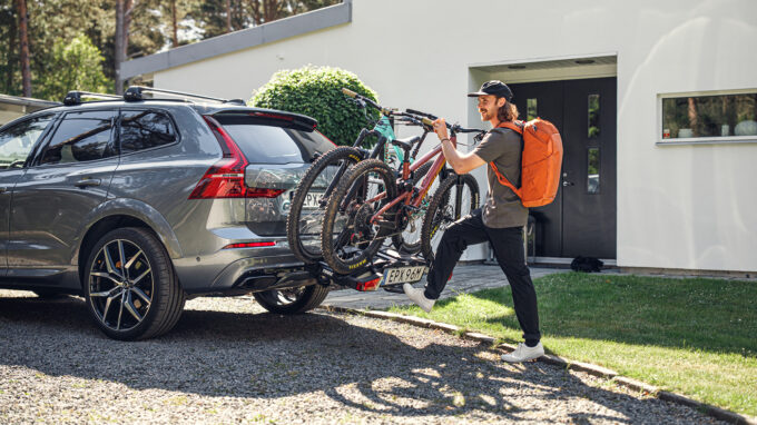 Man attaching his bikes to the car racks for bikes