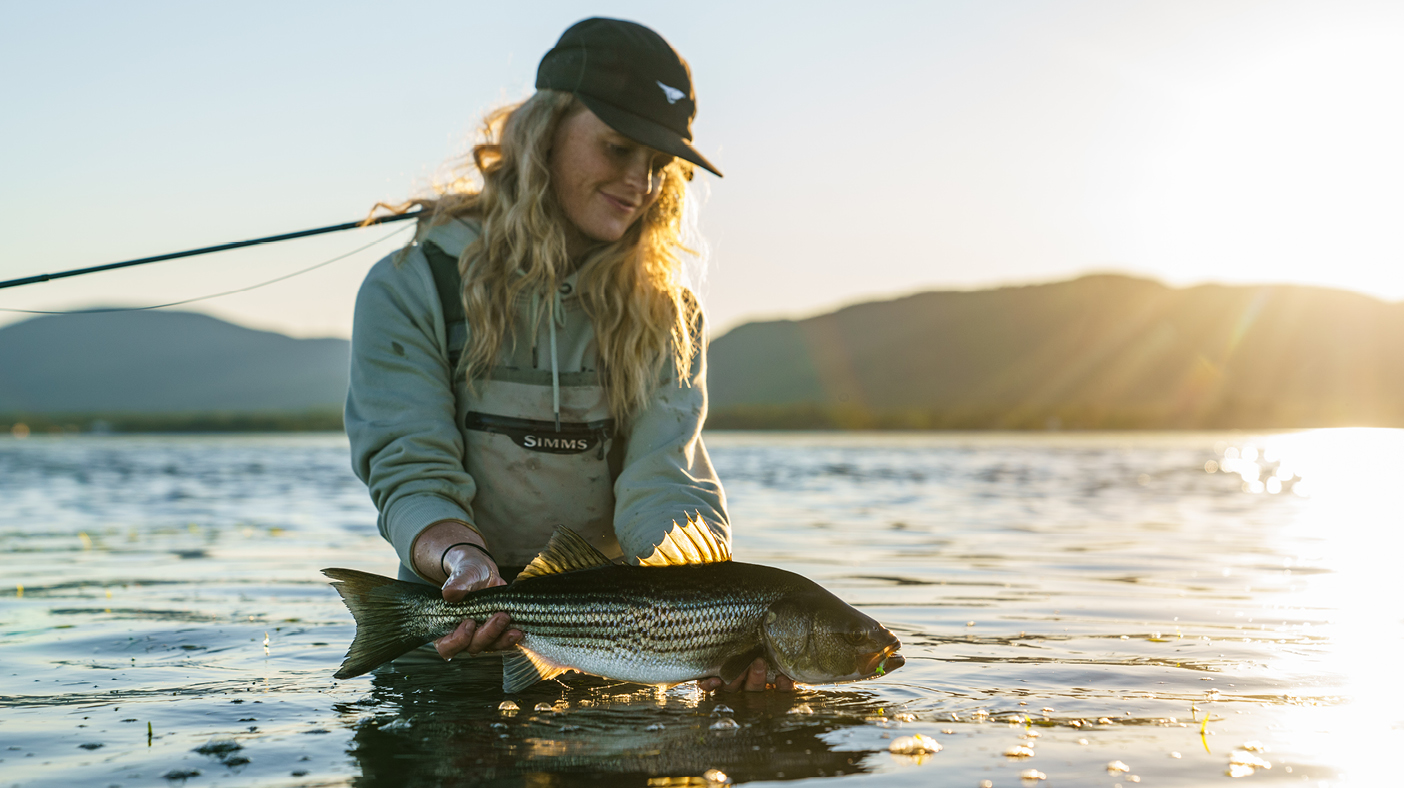 Woman who just caught a striped bass